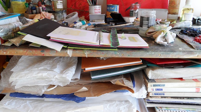 studio-sketch-books-and-collage-materials-taking-over-the-workspace